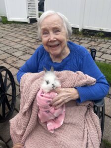 Residents, families, and staff enjoying a summer cookout together at Christopher House in Worcester, Massachusetts.